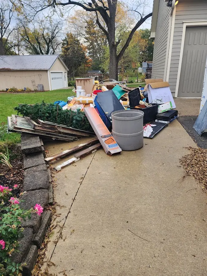 Dumpster being loaded with debris for Estate Cleanout Dumpster Rental in Florence